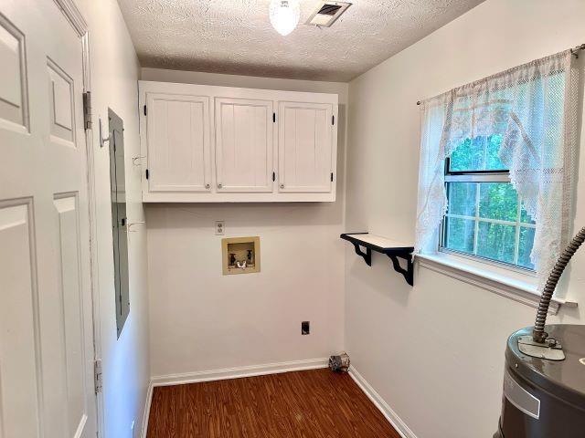 60 Parkman Trl, Covington, GA 30016 - washroom featuring water heater, dark wood-style flooring, washer hookup, a textured ceiling, and baseboards