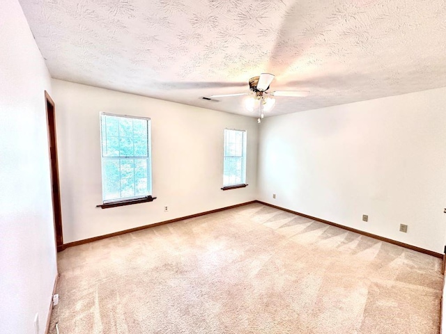 60 Parkman Trl, Covington, GA 30016 - spare room with light carpet, a textured ceiling, baseboards, and a ceiling fan