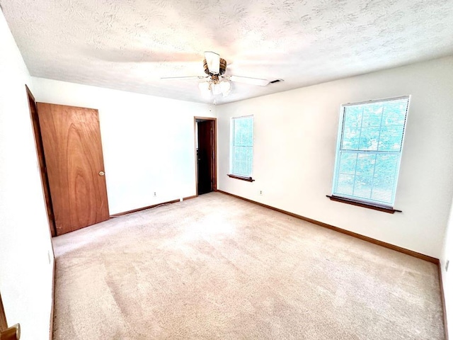 60 Parkman Trl, Covington, GA 30016 - empty room featuring light colored carpet, baseboards, a textured ceiling, and ceiling fan