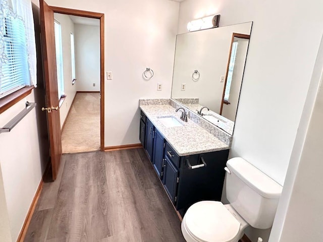 60 Parkman Trl, Covington, GA 30016 - bathroom with wood finished floors, toilet, vanity, and baseboards