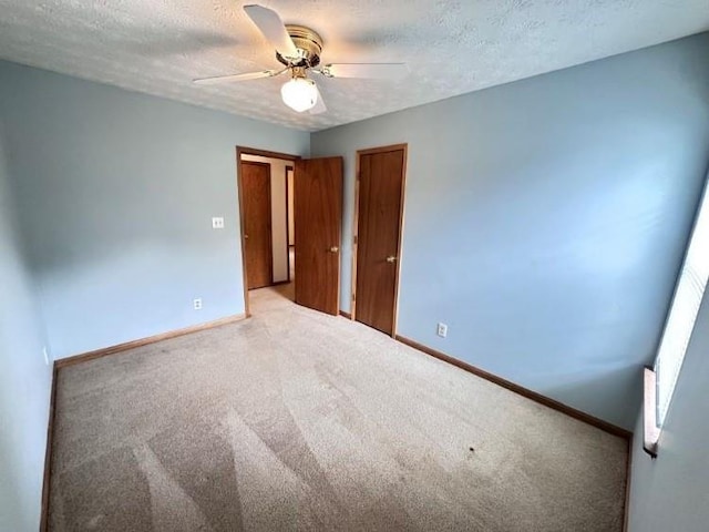 60 Parkman Trl, Covington, GA 30016 - carpeted empty room featuring a ceiling fan, baseboards, and a textured ceiling