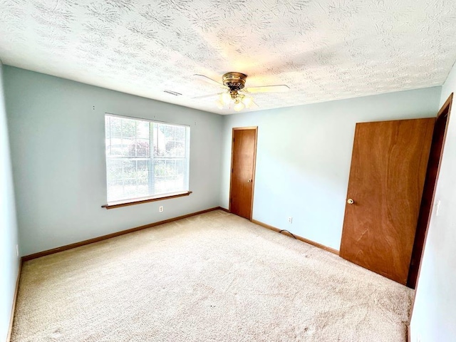 60 Parkman Trl, Covington, GA 30016 - carpeted empty room featuring ceiling fan, baseboards, and a textured ceiling