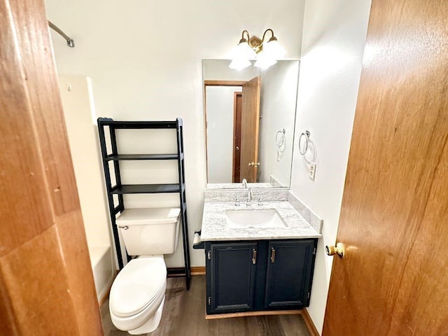 60 Parkman Trl, Covington, GA 30016 - bathroom with vanity, wood finished floors, toilet, baseboards, and shower / bathtub combination