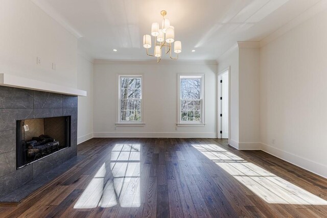 kitchen featuring sink, hanging light fixtures, dark hardwood / wood-style flooring, an island with sink, and wall chimney range hood