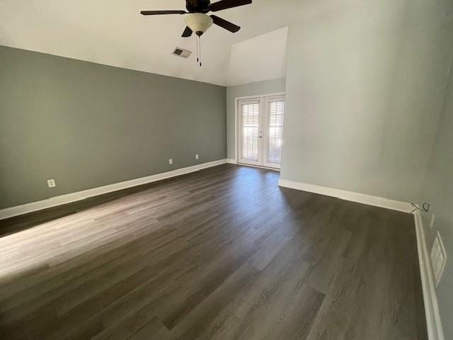 spare room with lofted ceiling, dark wood-type flooring, ceiling fan, and french doors