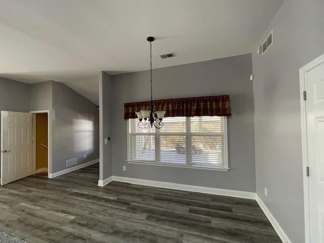 unfurnished dining area featuring lofted ceiling, dark wood-type flooring, and a notable chandelier