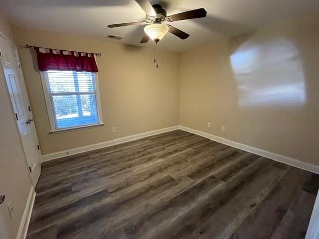 spare room with ceiling fan and dark hardwood / wood-style flooring