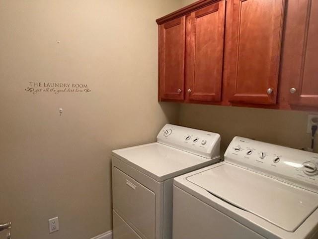 washroom with separate washer and dryer and cabinets