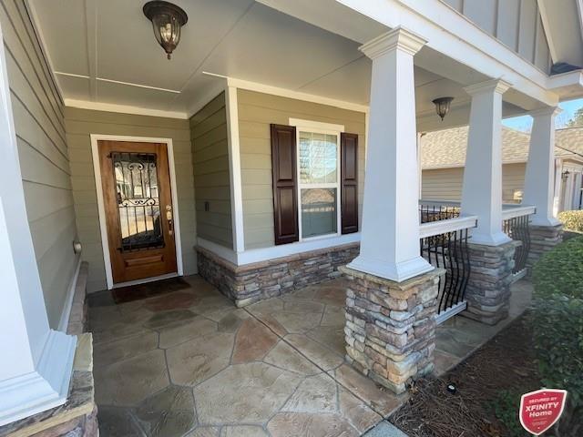 view of exterior entry with covered porch