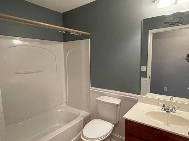 full bathroom with toilet, vanity, and shower / bath combination