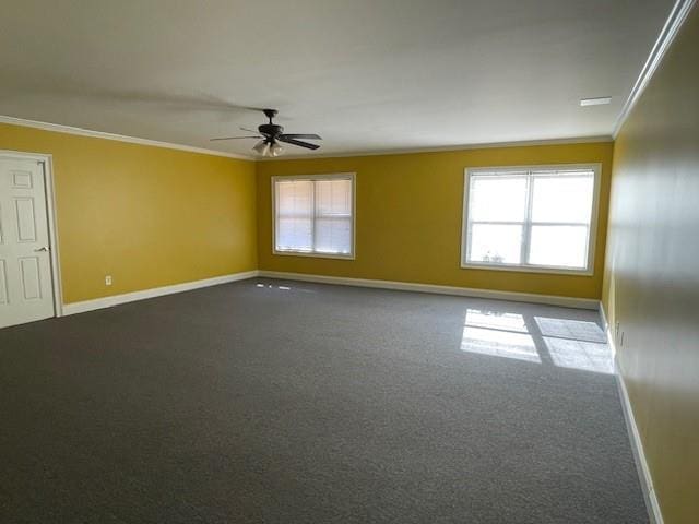 carpeted spare room with ceiling fan, a wealth of natural light, and crown molding