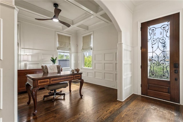 foyer entrance featuring ceiling fan, dark wood-style flooring, a decorative wall, beam ceiling, and coffered ceiling