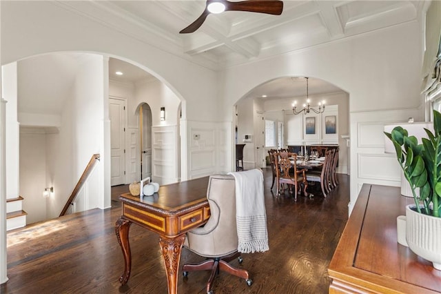 dining room with beam ceiling, ceiling fan with notable chandelier, ornamental molding, coffered ceiling, and dark wood-type flooring