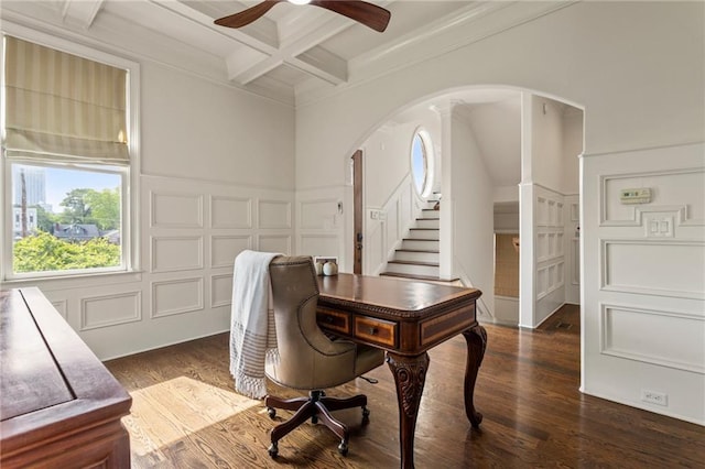 office space with a ceiling fan, a decorative wall, beam ceiling, arched walkways, and coffered ceiling
