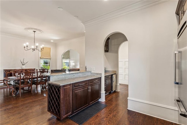 kitchen featuring dark wood-style flooring, dark brown cabinetry, a notable chandelier, arched walkways, and ornamental molding