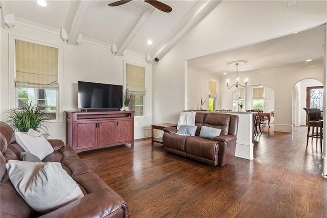 living room featuring arched walkways, plenty of natural light, and dark wood-type flooring