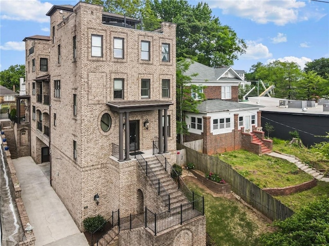 view of front of house with fence and brick siding