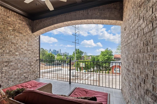 view of patio / terrace with a ceiling fan and a balcony