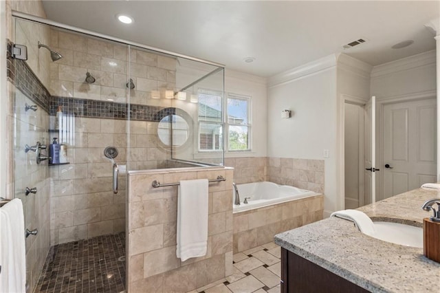 full bathroom with visible vents, vanity, a garden tub, and a shower stall