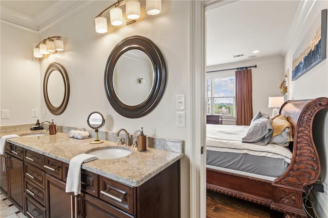 ensuite bathroom featuring a sink, double vanity, ensuite bathroom, visible vents, and ornamental molding