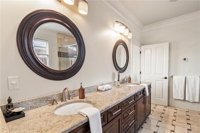full bath with double vanity, a sink, crown molding, and a shower stall