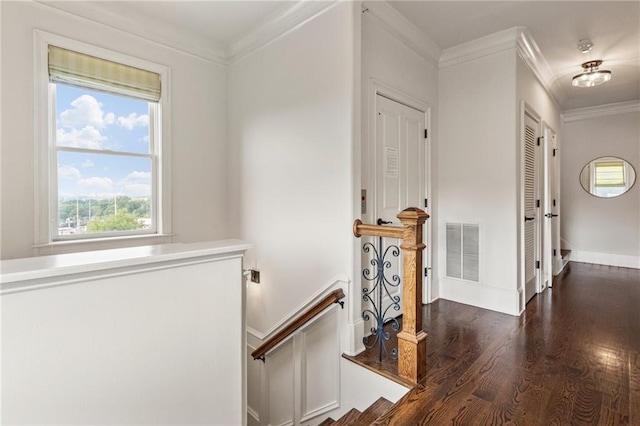 hall featuring crown molding, baseboards, an upstairs landing, wood finished floors, and visible vents