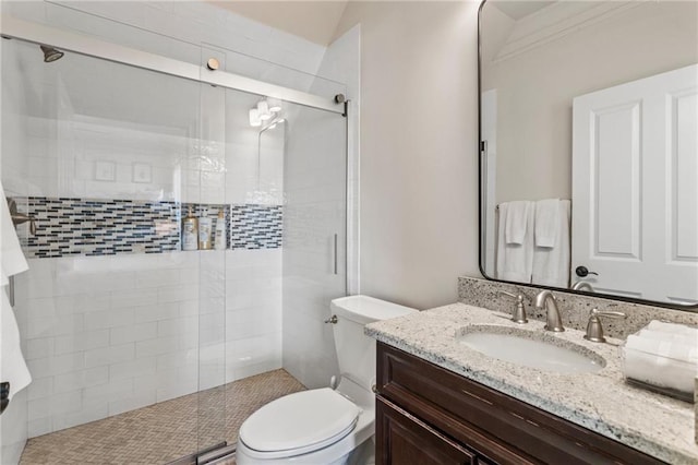 full bath featuring toilet, a stall shower, and vanity