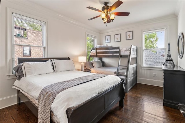 bedroom with baseboards, ornamental molding, ceiling fan, and dark wood-style floors