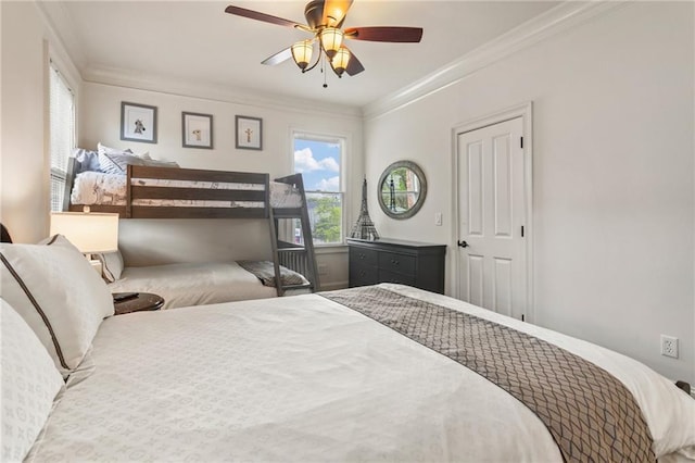 bedroom featuring crown molding and a ceiling fan