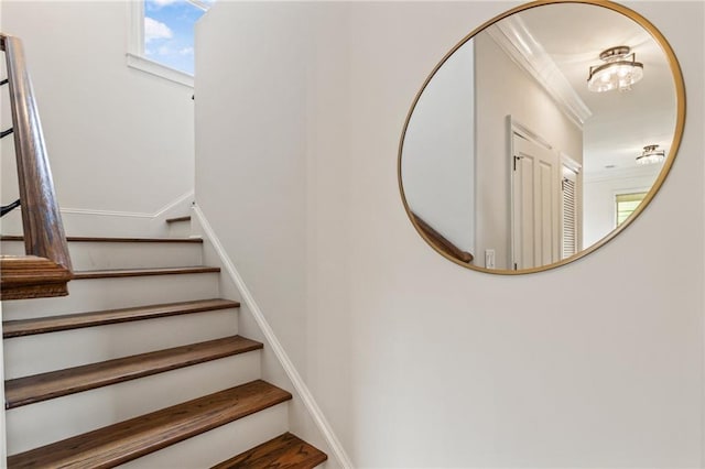 stairway featuring a chandelier