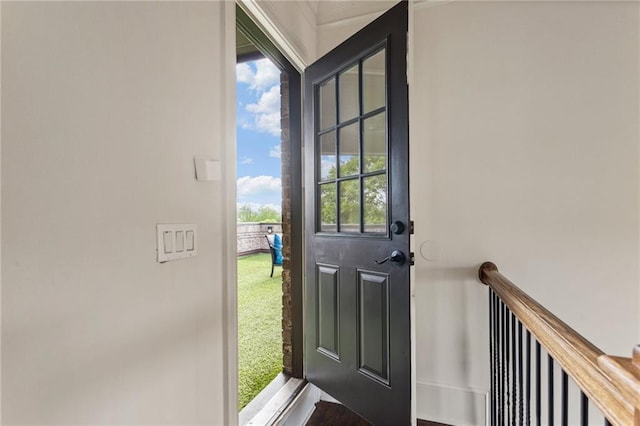 doorway to outside featuring baseboards