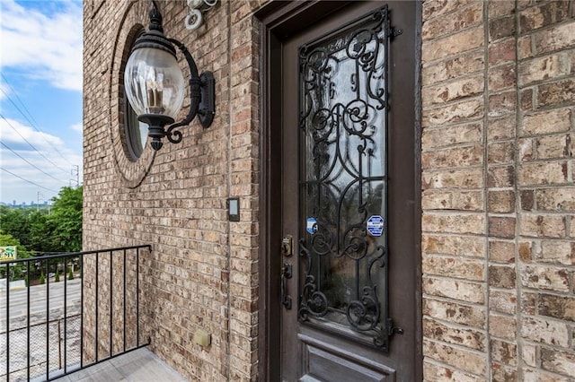 property entrance featuring brick siding
