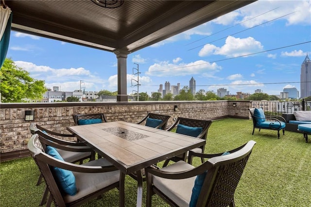 balcony featuring a view of city and outdoor dining area