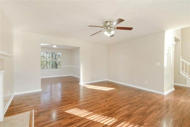 unfurnished living room featuring hardwood / wood-style floors and ceiling fan