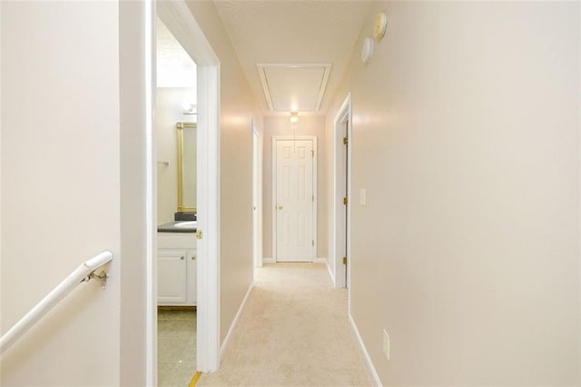 hallway featuring light colored carpet