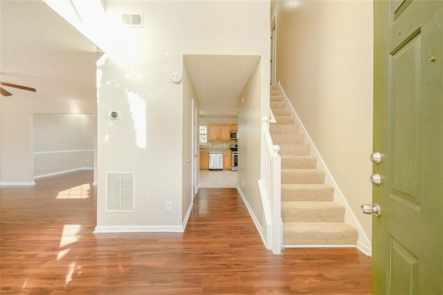 foyer entrance with hardwood / wood-style flooring and ceiling fan