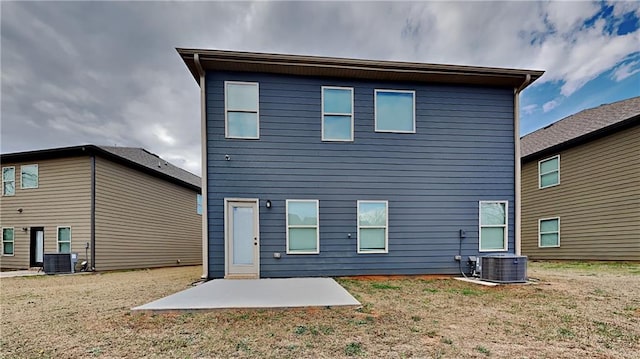 rear view of house with a patio, a yard, and cooling unit