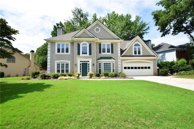340 Channings Lake Dr, Lawrenceville, GA 30043 - colonial inspired home with driveway, a chimney, a front lawn, and stucco siding