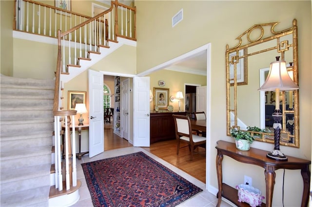 340 Channings Lake Dr, Lawrenceville, GA 30043 - entryway with stairway, crown molding, and a towering ceiling
