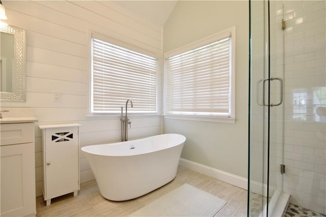 340 Channings Lake Dr, Lawrenceville, GA 30043 - bathroom with vanity, a stall shower, a soaking tub, and vaulted ceiling