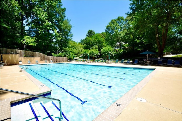 340 Channings Lake Dr, Lawrenceville, GA 30043 - community pool featuring a patio area and view of scattered trees