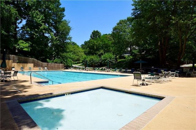 340 Channings Lake Dr, Lawrenceville, GA 30043 - community pool with a patio and view of scattered trees