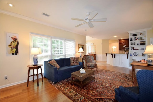 340 Channings Lake Dr, Lawrenceville, GA 30043 - living room featuring ceiling fan, light wood-type flooring, crown molding, and a wainscoted wall