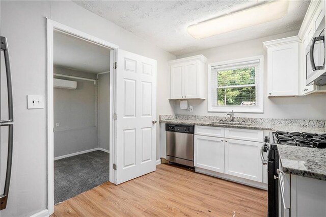 2623 Rex Ave SW, Atlanta, GA 30331 - kitchen featuring white cabinets, light stone counters, a sink, and appliances with stainless steel finishes