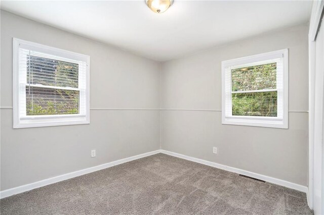 2623 Rex Ave SW, Atlanta, GA 30331 - spare room with carpet, baseboards, visible vents, and plenty of natural light