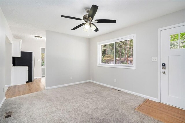 2623 Rex Ave SW, Atlanta, GA 30331 - interior space featuring light colored carpet, baseboards, a ceiling fan, and visible vents