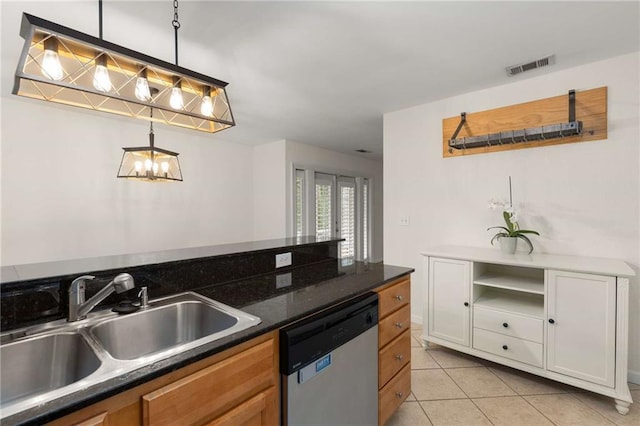 kitchen featuring sink, dishwasher, white cabinets, light tile patterned flooring, and decorative light fixtures