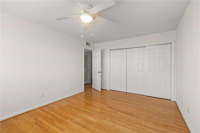 unfurnished bedroom featuring light hardwood / wood-style floors, a closet, and ceiling fan