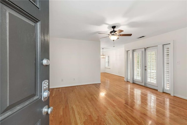 interior space with ceiling fan and light hardwood / wood-style flooring