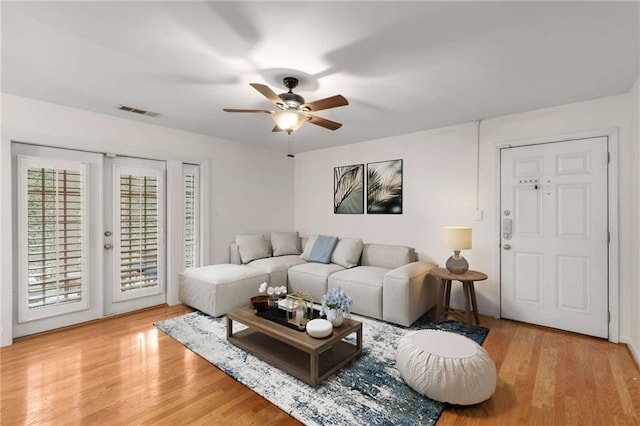 living room featuring ceiling fan and light wood-type flooring